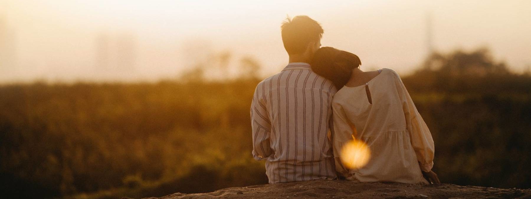 man and woman near grass field