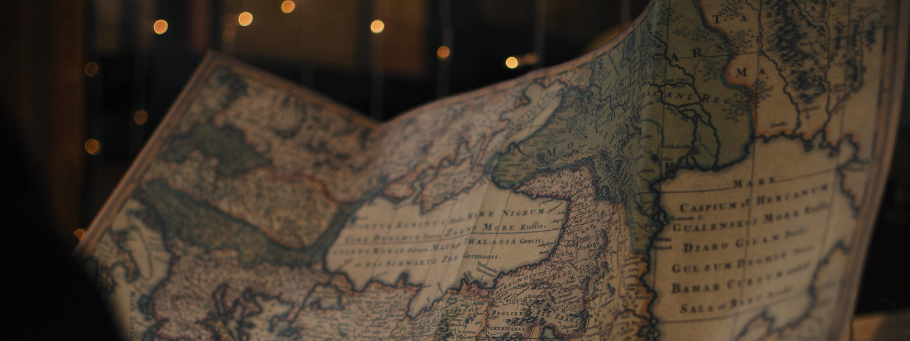 Crop person with ancient world map