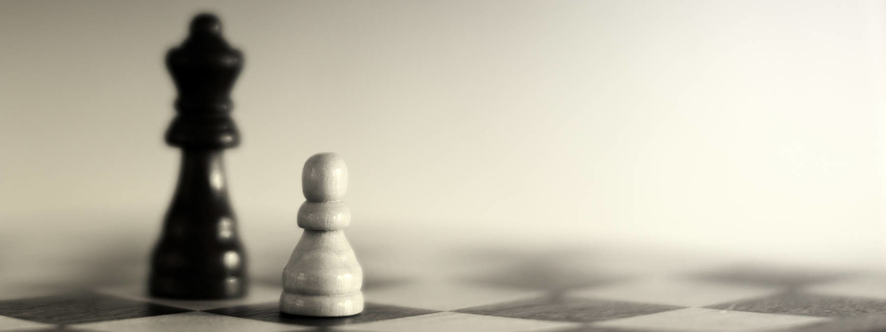 Grayscale photography of two chess pieces