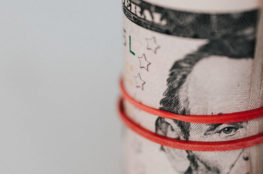 Roll of american dollars tightened with red band